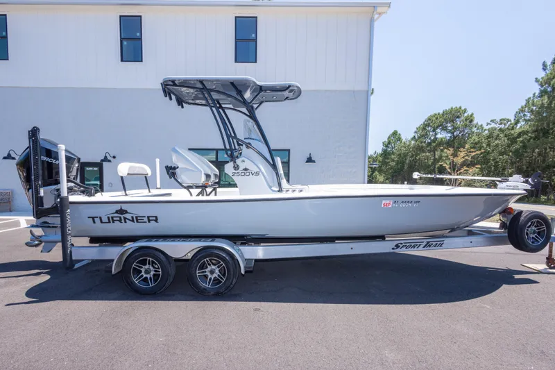 Slide: The Image of 2020 Turner Boatworks 2500 VS on trailer, parked outdoors near a building. - 3
