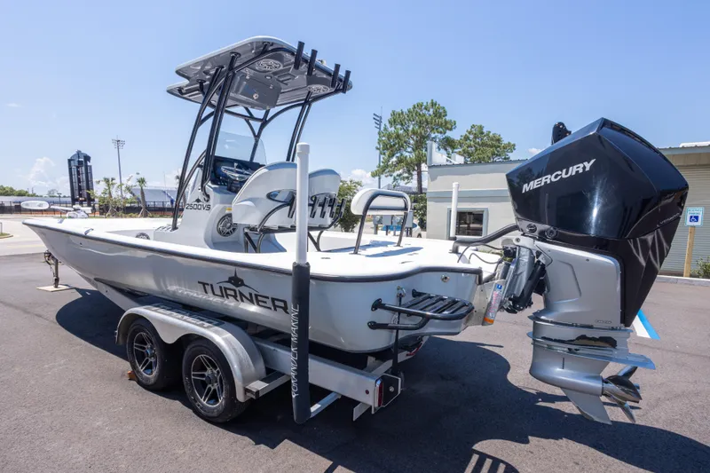 Slide: The Image of 2020 Turner Boatworks 2500 VS with Mercury engine on a trailer, parked outdoors. - 4