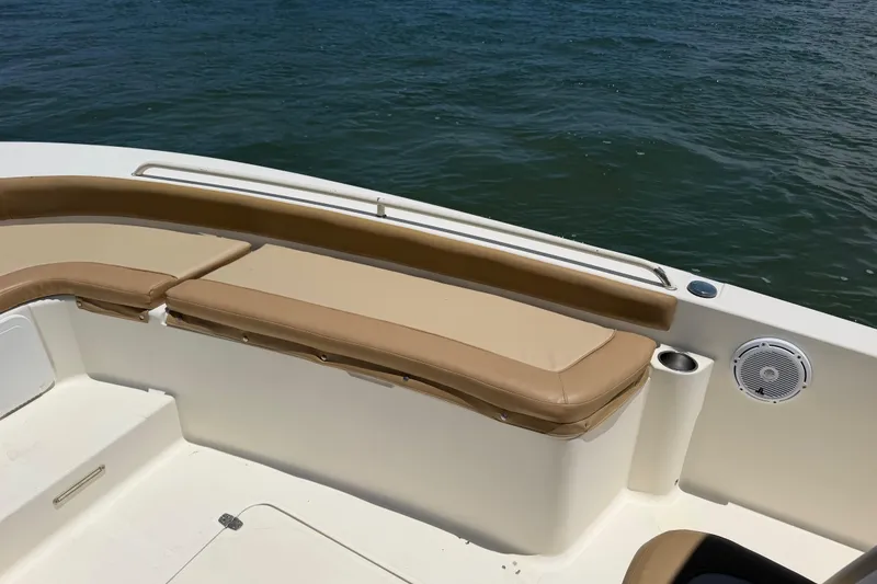 Slide: The Image of 2012 Scout 251 XS boat interior with tan seating and ocean view. - 16