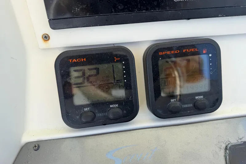 Slide: The Image of Yamaha tachometer and speed fuel gauges on a 2012 Scout 251 XS boat dashboard. - 32