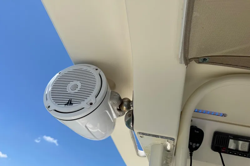 Slide: The Image of Boat speaker on a 2012 Scout 251 XS, mounted under a canopy against a clear blue sky. - 31