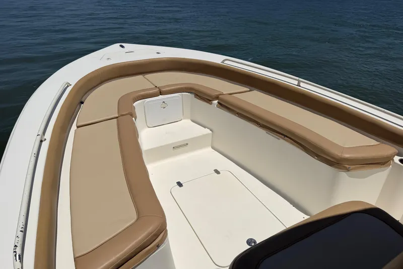 Slide: The Image of 2012 Scout 251 XS boat interior with tan seating, on calm water. - 14