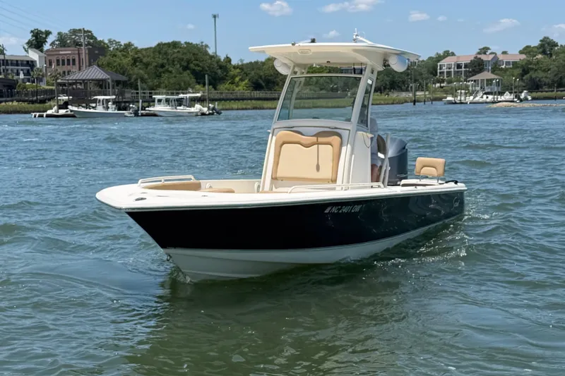Slide: The Image of 2012 Scout 251 XS boat on water, featuring sleek design and modern amenities. - 2