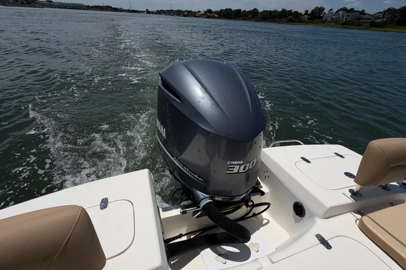Slide: The Image of 2012 Scout 251 XS boat with Yamaha 300 engine cruising on a scenic waterway. - 35