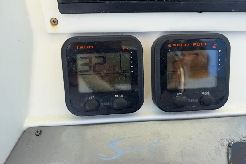 Slide: The Image of Dashboard of a 2012 Scout 251 XS boat showing tachometer and speed fuel gauges. - 33