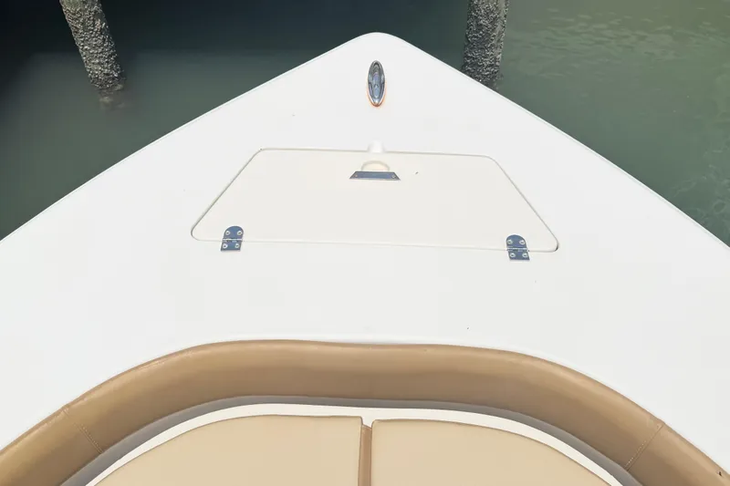 Slide: The Image of Bow of a 2012 Scout 251 XS boat with tan seating and storage hatch. - 3