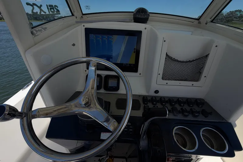 Slide: The Image of 2012 Scout 251 XS boat dashboard with steering wheel and navigation screen. - 22