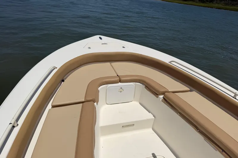 Slide: The Image of 2012 Scout 251 XS boat interior with tan seating on calm water. - 15