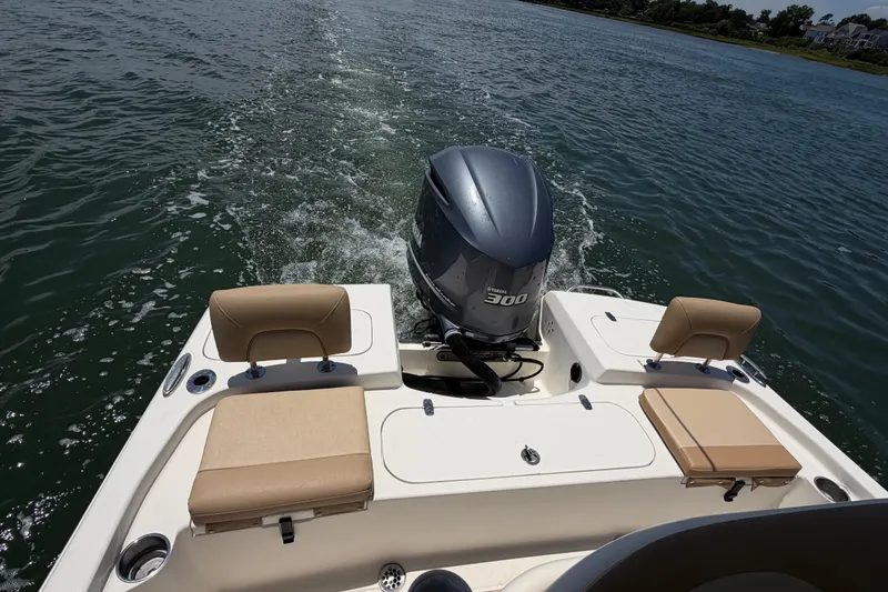 Slide: The Image of 2012 Scout 251 XS boat with Yamaha 300 engine cruising on water. - 27