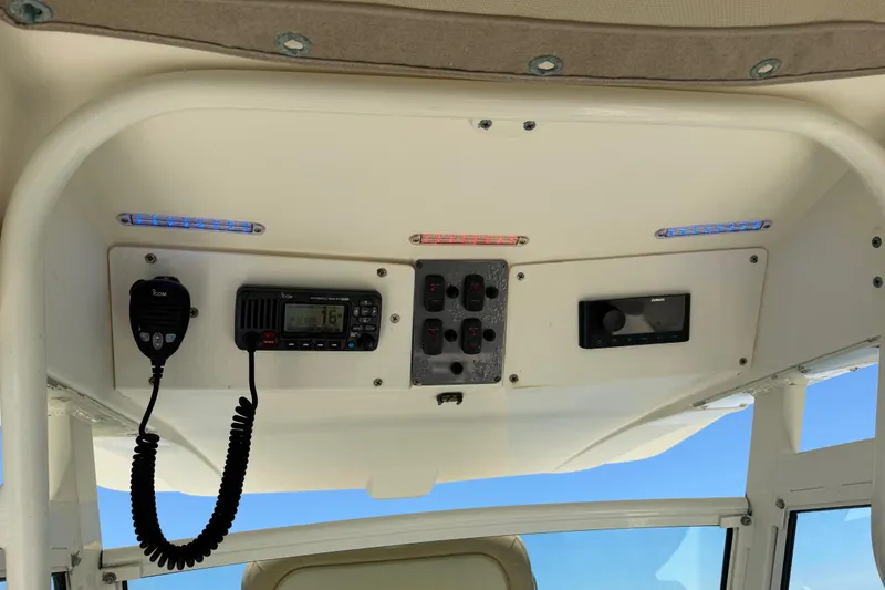 Slide: The Image of 2012 Scout 251 XS boat console with radio and control panel. - 37