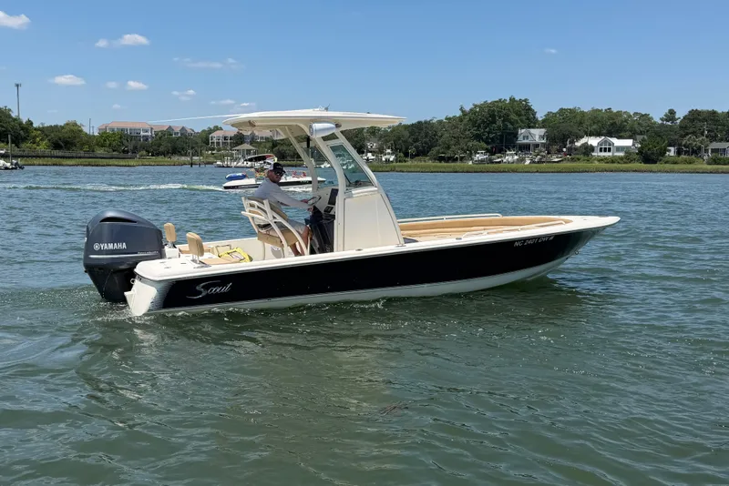 Slide: The Image of 2012 Scout 251 XS boat cruising on a sunny day with Yamaha outboard motor. - 12