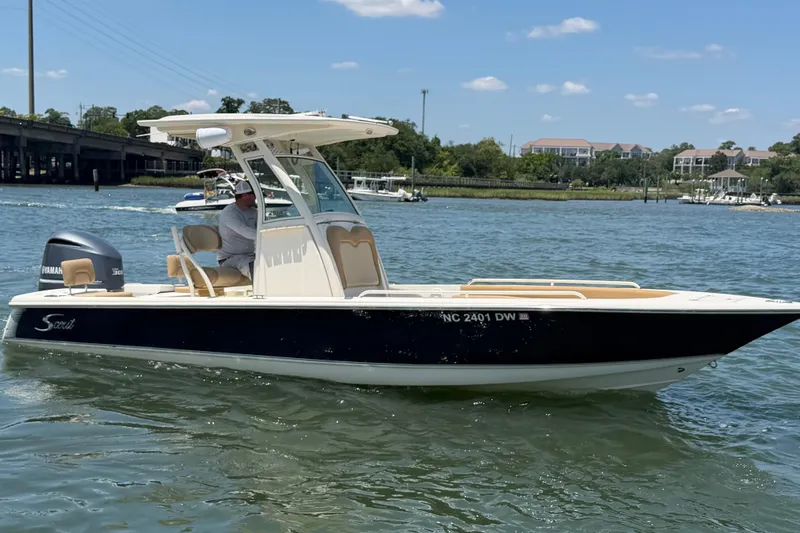 Slide: The Image of 2012 Scout 251 XS boat on water with Yamaha engine, under clear sky. - 1