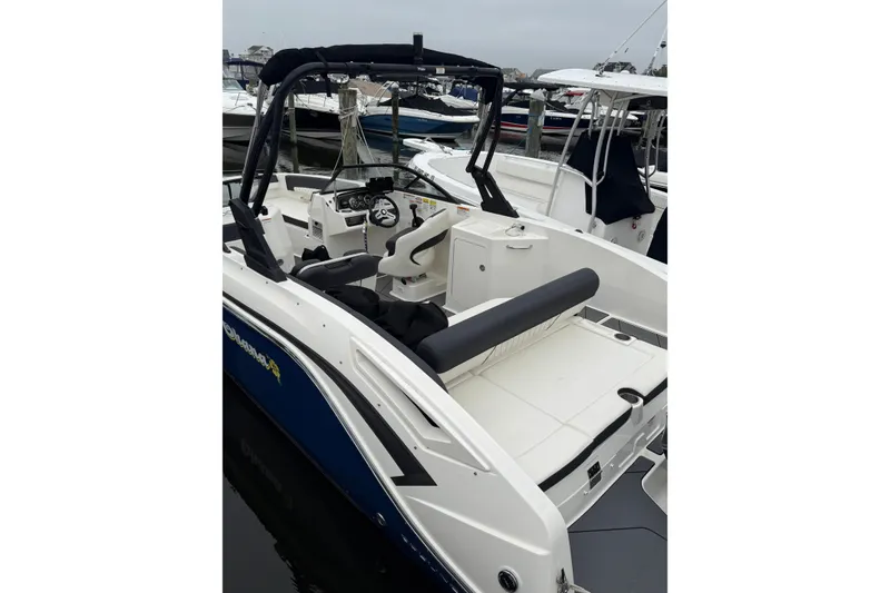 Slide: The Image of 2021 Bayliner DX 2200 boat with sleek design, docked at marina. - 6