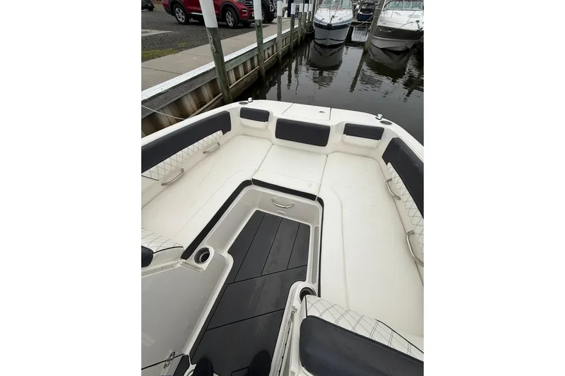 Slide: The Image of 2021 Bayliner DX 2200 boat interior with cushioned seating and sleek design. - 9