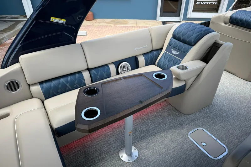 Slide: The Image of Luxurious seating area on 2026 Bennington 27 QSBAT2 pontoon boat with elegant table and cup holders. - 10