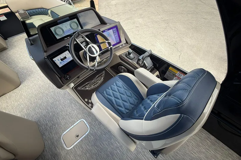 Slide: The Image of Luxurious helm of 2026 Bennington 27 QSBAT2 boat with advanced navigation displays. - 12