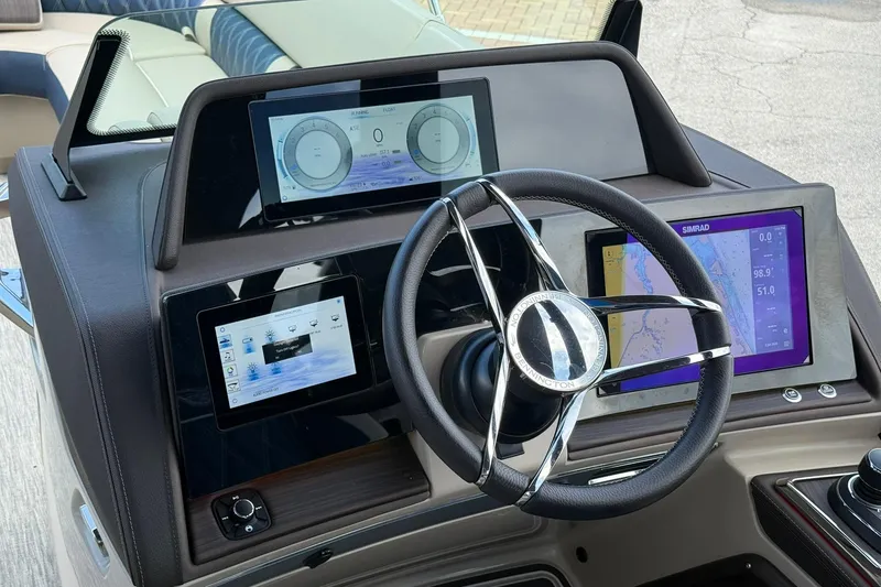Slide: The Image of Helm of 2026 Bennington 27 QSBAT2 with advanced navigation displays and steering wheel. - 14