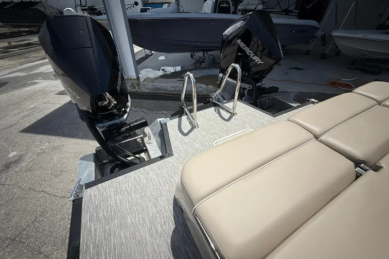 Slide: The Image of 2026 Bennington 27 QSBAT2 boat with Mercury outboard engines and beige seating. - 3