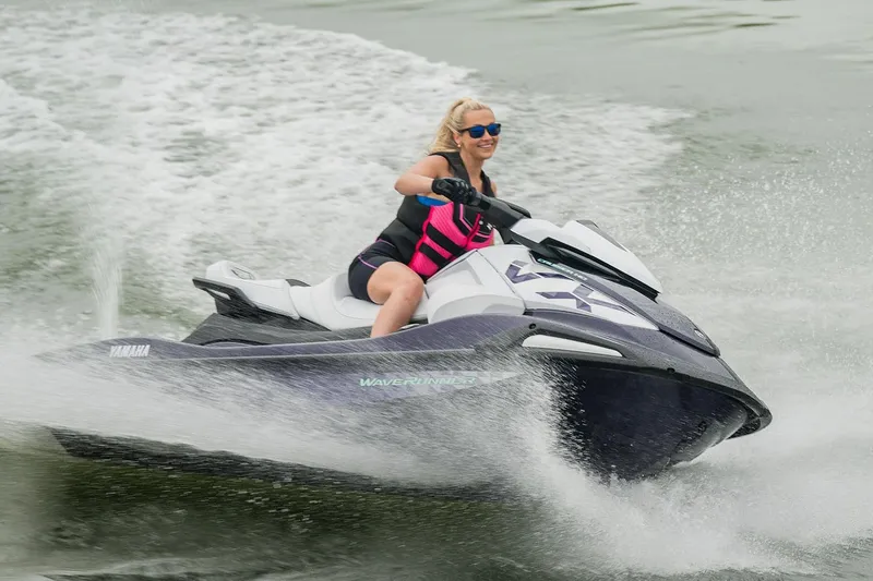 Slide: The Image of Manufacturer Provided Image: Person riding 2026 Yamaha WaveRunner VX Cruiser HO on water, wearing a pink life jacket. - 2