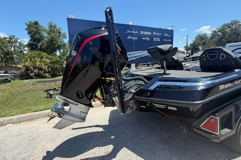 Slide: The Image of 2023 Ranger Z521R boat with powerful outboard motor, parked outdoors on a sunny day. - 18