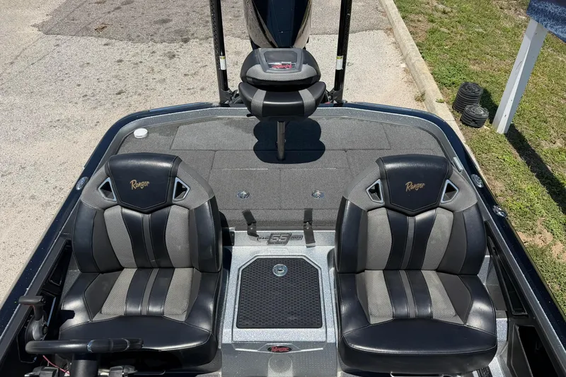 Slide: The Image of 2023 Ranger Z521R boat interior with dual black and gray seats. - 9