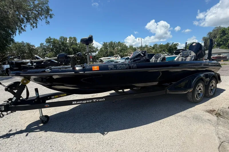 Slide: The Image of 2023 Ranger Z521R boat on trailer under clear blue sky. - 20