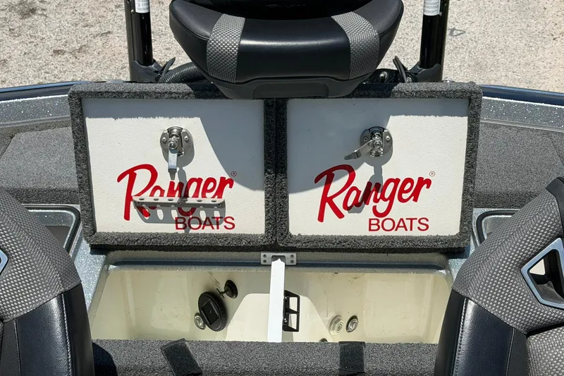 Slide: The Image of 2023 Ranger Z521R boat storage compartments with logo, featuring secure latches and seating. - 14