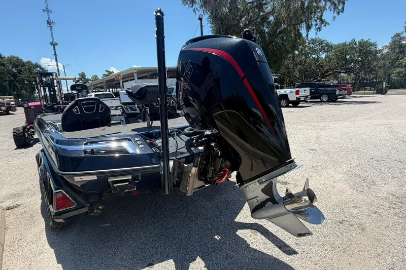 Slide: The Image of 2023 Ranger Z521R boat with powerful outboard motor, parked outdoors on a sunny day. - 19