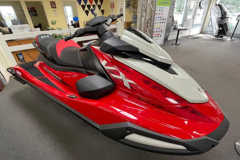 Slide: The Image of 2026 Yamaha WaveRunner VX Cruiser in showroom, vibrant red and gray design. - 1