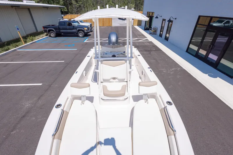 Slide: The Image of 2023 Robalo 206 Cayman boat in parking lot, showcasing sleek design and spacious seating. - 22
