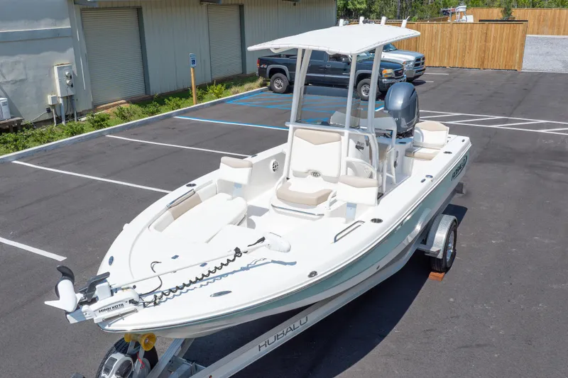 Slide: The Image of 2023 Robalo 206 Cayman boat on trailer in parking lot, featuring sleek design and modern amenities. - 40