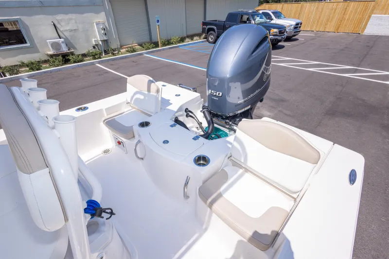 Slide: The Image of 2023 Robalo 206 Cayman boat with Yamaha 150 engine in parking lot. - 31