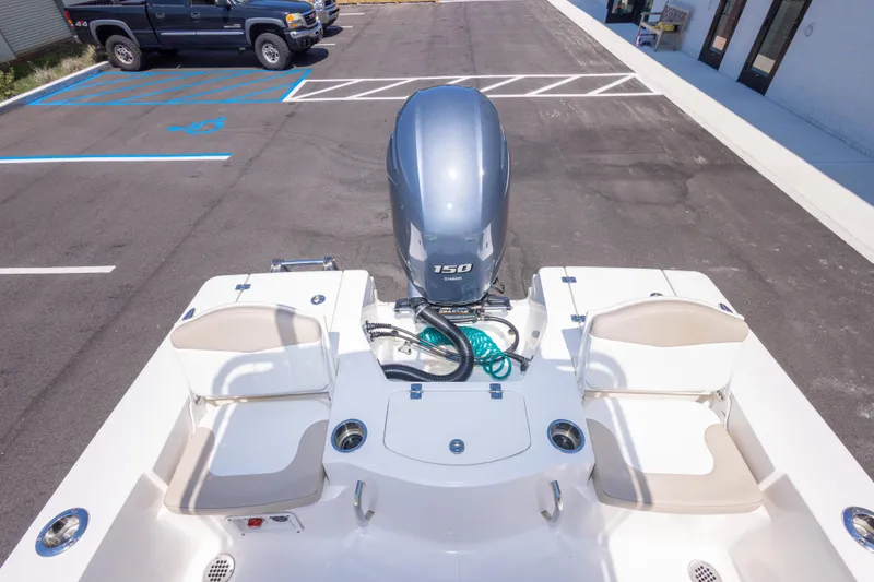 Slide: The Image of 2023 Robalo 206 Cayman boat with Yamaha 150 engine, parked in a lot. - 29