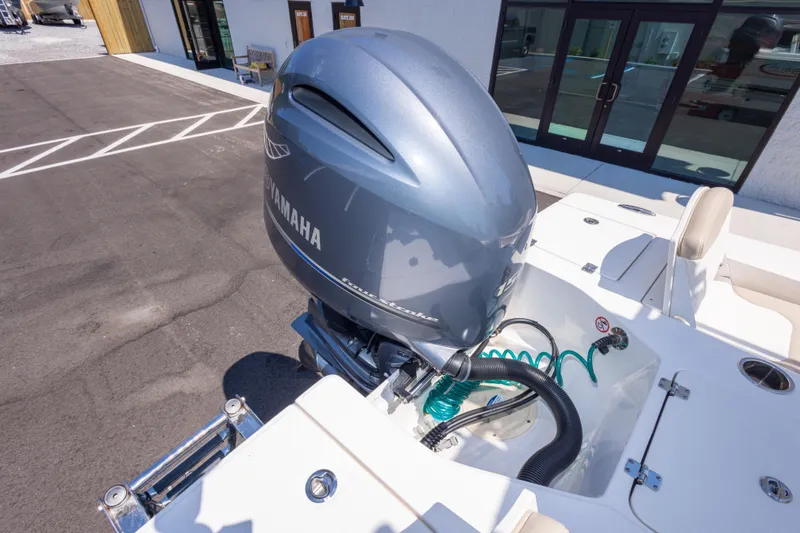 Slide: The Image of 2023 Robalo 206 Cayman boat with Yamaha outboard motor, parked outdoors. - 33