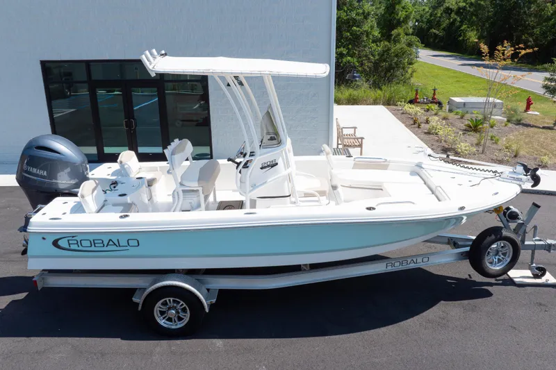 Slide: The Image of 2023 Robalo 206 Cayman boat on trailer, parked outdoors near a building. - 37