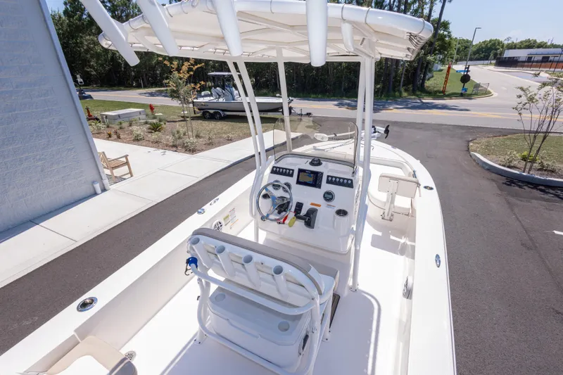 Slide: The Image of 2023 Robalo 206 Cayman boat with center console and T-top, parked outdoors. - 10