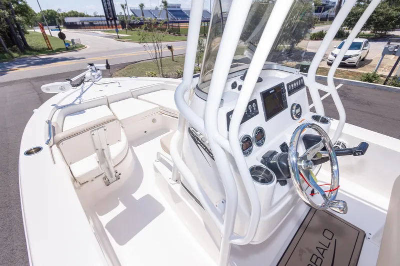 Slide: The Image of 2023 Robalo 206 Cayman boat interior with steering console and seating area. - 21
