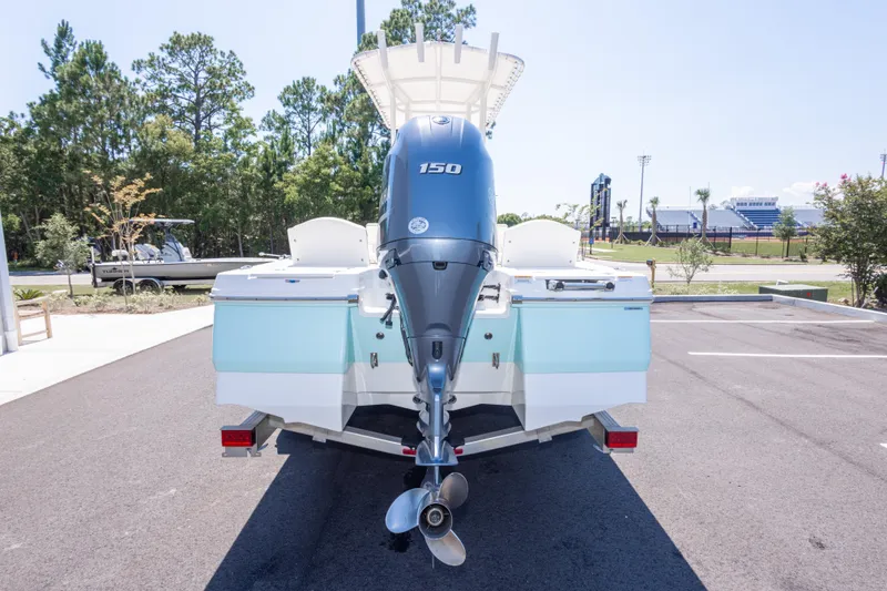 Slide: The Image of 2023 Robalo 206 Cayman boat with 150 HP engine, parked outdoors. - 4