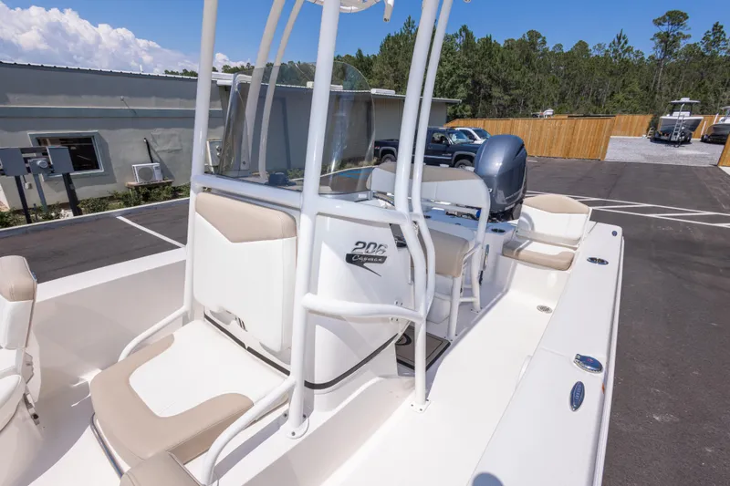 Slide: The Image of 2023 Robalo 206 Cayman boat with sleek design, parked outdoors on a sunny day. - 26
