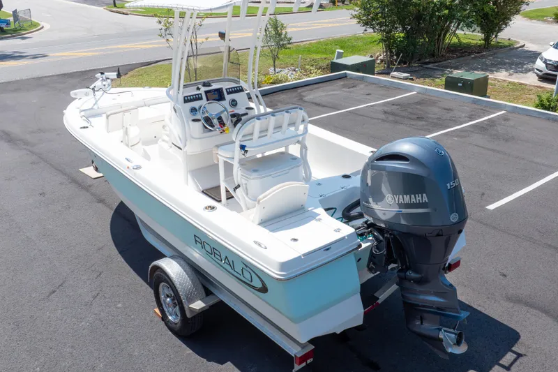 Slide: The Image of 2023 Robalo 206 Cayman boat with Yamaha 150 engine, parked on a trailer. - 34