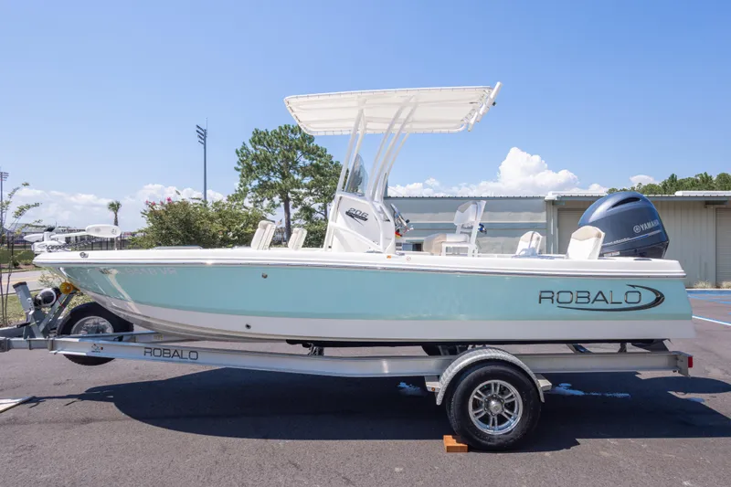 Slide: The Image of 2023 Robalo 206 Cayman boat on trailer, side view, outdoors under clear sky. - 6