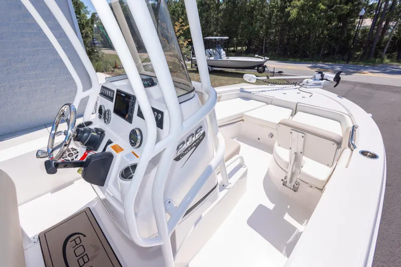 Slide: The Image of 2023 Robalo 206 Cayman boat interior with steering console and seating area. - 20