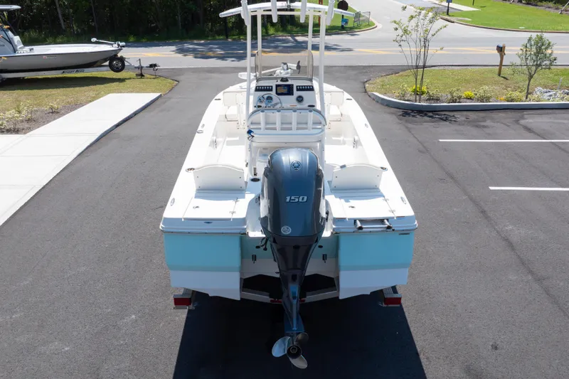 Slide: The Image of 2023 Robalo 206 Cayman boat with 150 HP engine, parked on asphalt. - 35