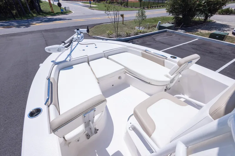 Slide: The Image of 2023 Robalo 206 Cayman boat interior with white seating and modern design. - 18