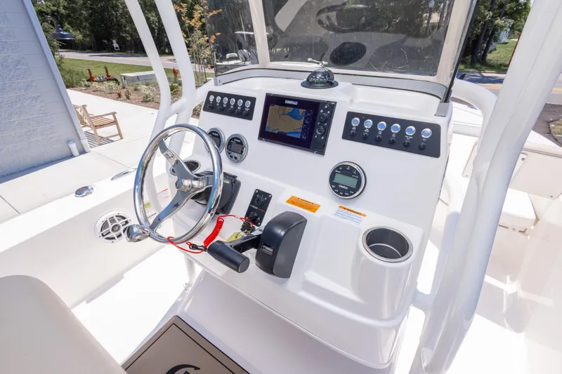 Slide: The Image of 2023 Robalo 206 Cayman boat dashboard with steering wheel and navigation controls. - 15
