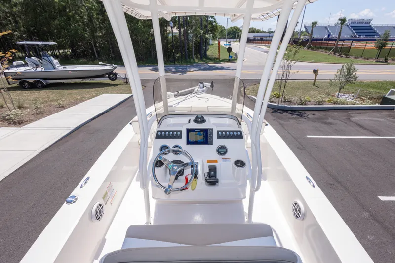 Slide: The Image of 2023 Robalo 206 Cayman boat dashboard with steering wheel and navigation display. - 12