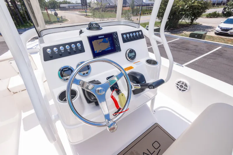 Slide: The Image of 2023 Robalo 206 Cayman boat dashboard with steering wheel and navigation system. - 16