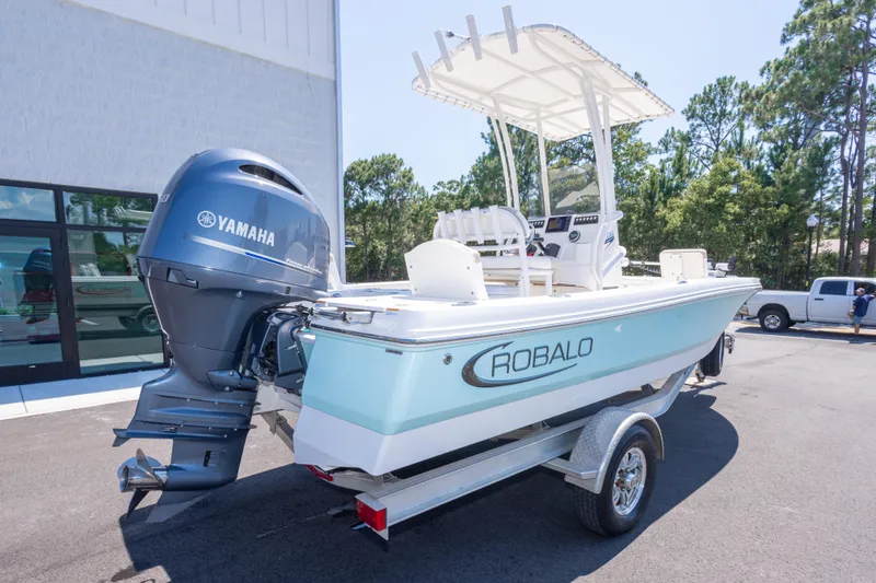 Slide: The Image of 2023 Robalo 206 Cayman boat with Yamaha engine on trailer, parked outdoors. - 3