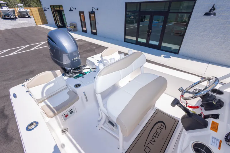 Slide: The Image of 2023 Robalo 206 Cayman boat interior with seating and steering wheel. - 27
