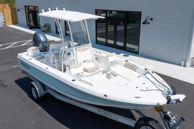 Slide: The Image of 2023 Robalo 206 Cayman boat on trailer, parked outside a building. - 38